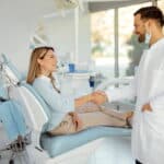 A woman shaking hands with her new dentist.
