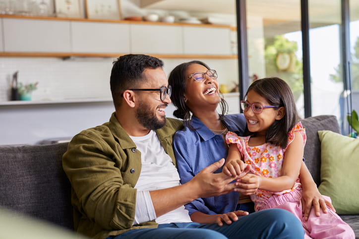 A family smiling and laughing together. 