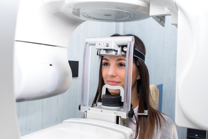Girl taking digital 3d panoramic dental x-ray.