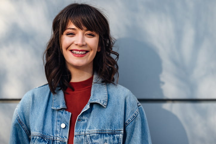 A woman smiling with braces. 